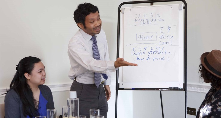 A teacher teaches young people Japanese at Asia House's first Open Your Eyes to Asian Languages workshop