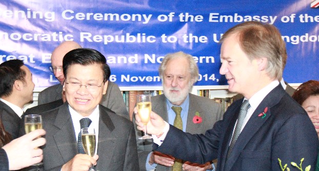 Laos Deputy Prime Minister Thongloun Sisoulith and UK Minister of State Hugo Swire toast the reopening