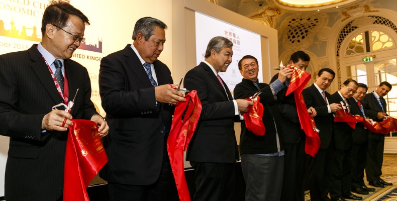 Speakers and sponsors at the World Chinese Economic Summit cut a ribbon to open the occasion.  Photo by Miles Willis